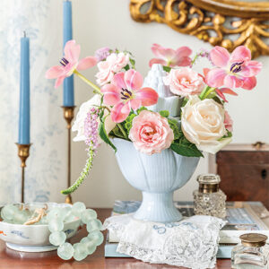 Southern Lady March-April 2022 Blue Case With Pink Flowers Next To Blue Candles On Gold Candle Sticks