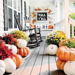 fall y'all sign with pumpkins on front porch