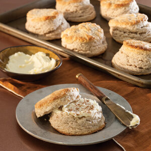 biscuits on cooking tray and plate with butter