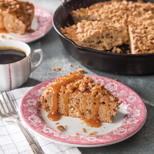 Sliced of apple coffee cake with a cup of coffee