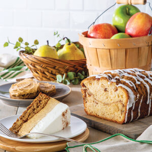 sliced cake in front of basket of apples
