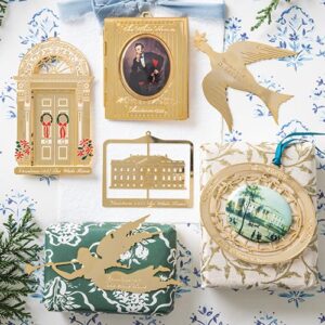 Gold ornaments laying on wrapped christmas presents