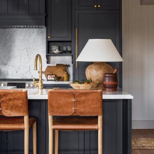 Black Cabinetry with brown leather chairs
