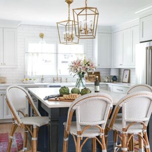 white and gold kitchen with black kitchen island