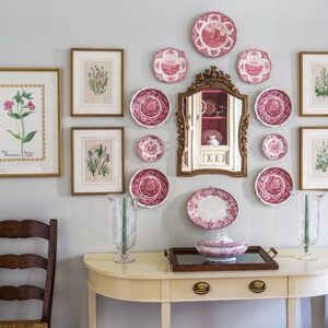 hallway table with pink floral wall decor above