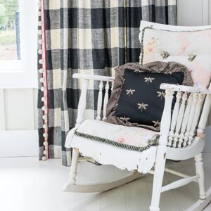 white antique rocking chair with pink design