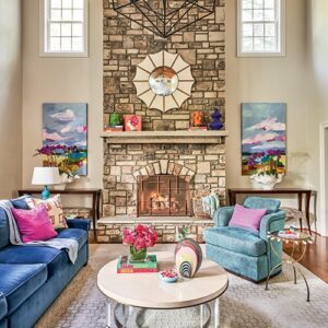 colorful living room decor and furniture in front of stone fireplace