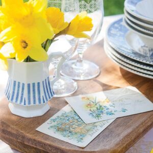 Daffodils in blue and white vase with notecards