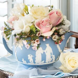 Floral arrangement in blue watering pot