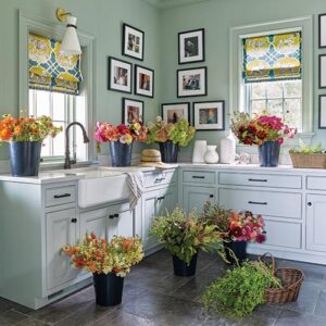 Sage and white kitchen with flower pots