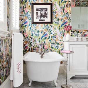Colorful floral bathroom wallpaper and bathtub