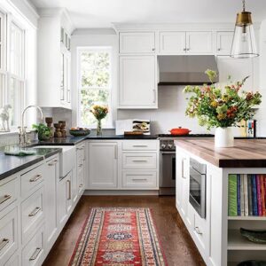 white kitchen with black counter tops
