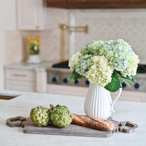 Flowers and cutting board in white kitchen