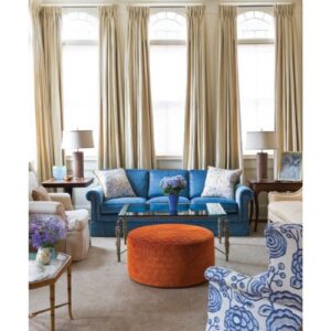 Southern Cottage Style 2025 feat. blue sofa in front of tall windows