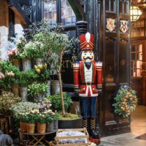 Victoria The Splendor of Christmas book interior photo featuring nutcracker outside of storefront