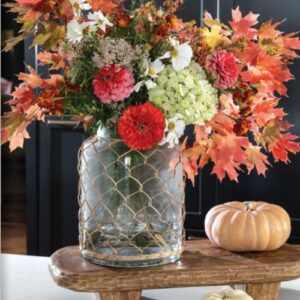The Cottage Journal Autumn arrangement on a table with a pumpkin