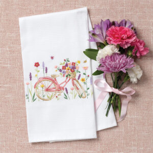 White tea towel with embroidered pink bicycle