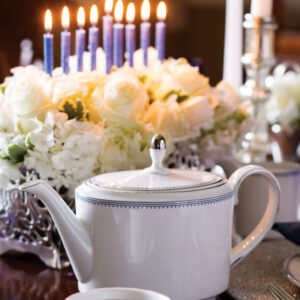 White teapot with flowers and candles