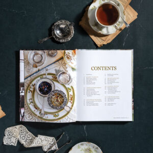 Comfort of Books and Tea internal spread with tea and ribbon on dark background