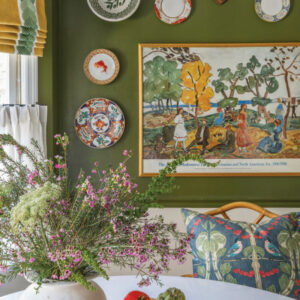 Painting on green wall with decorative plates