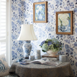Blue and white wallpaper, lamp and frames