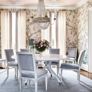 Dining space with blue chairs and rug