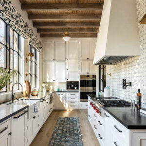 Kitchen with black countertops and white cabinets