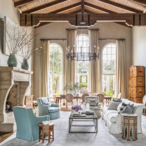 Living space with blue chairs and high ceilings