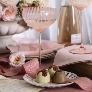 Pink cocktail glass with dessert