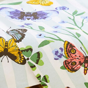 Butterfly tea towel with blue stripe and pink, purple butterflies and green leaves