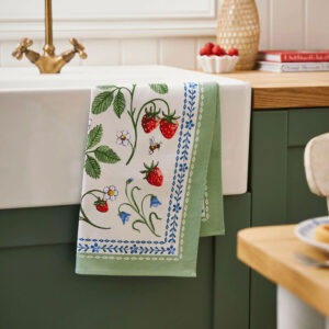 Tea towel with green vine, blue flowers, and strawberries