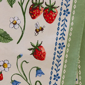 Tea towel with green vine, blue flowers, and strawberries