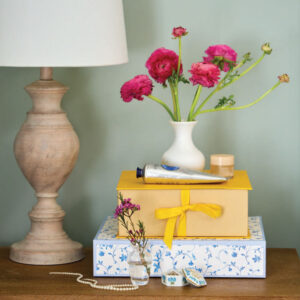 Lamp with flowers stacked on top of bins