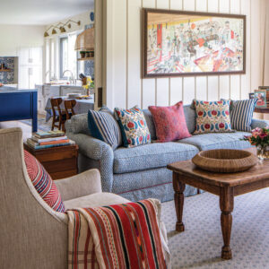 Living room with blue couch and art work