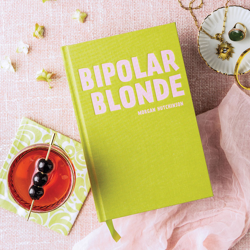 Bipolar Blonde cover with cocktail napkin, cocktail, and jewelry