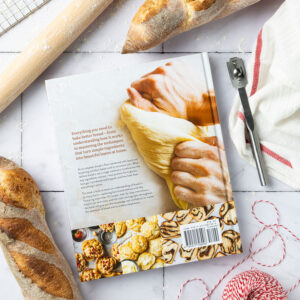 Bread Baker's Companion Back Cover with bread loaves, red string, and rolling pin