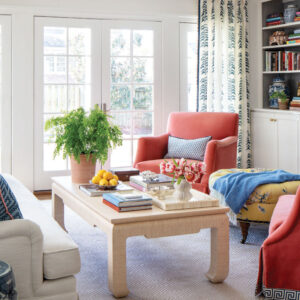 Sitting area with peach chairs, beige coffee table, and plant