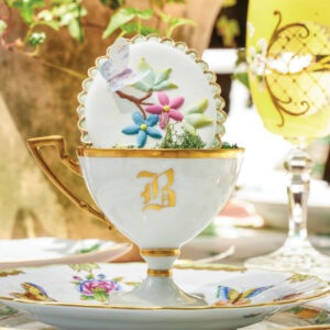 White porcelain bowl with gold accents on floral plate