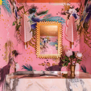 Pink bathroom with gold mirror and various pattern