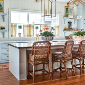Kitchen with gold accents and brown chairs