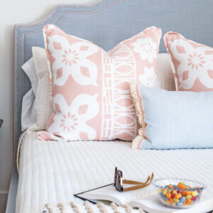 Bed with book and pink pillows