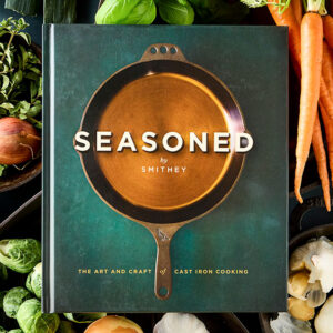 Seasoned styled cover surrounded by fresh vegetables