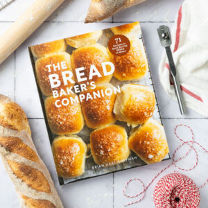Bread Baker's Companion cover with bread loaf, red string, and rolling pins