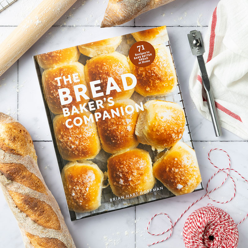 Bread Baker's Companion cover with bread loaf, red string, and rolling pins