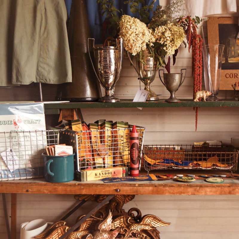 Brown shelf filled with knick-knacks and antiques