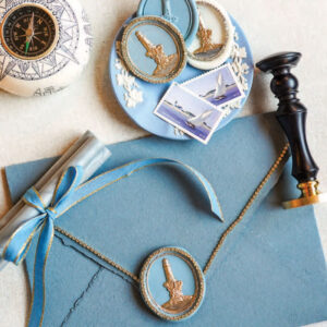 Stationery set with blue envelope, wax seal, and stamp