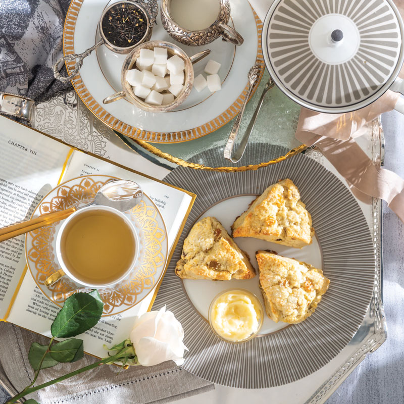 Scones on plate with side of tea
