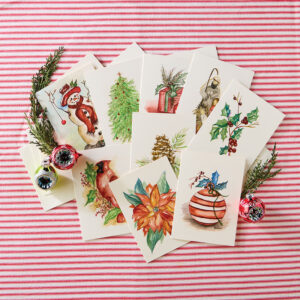 Holiday notecards on red and white stripe fabric with holly and ornament