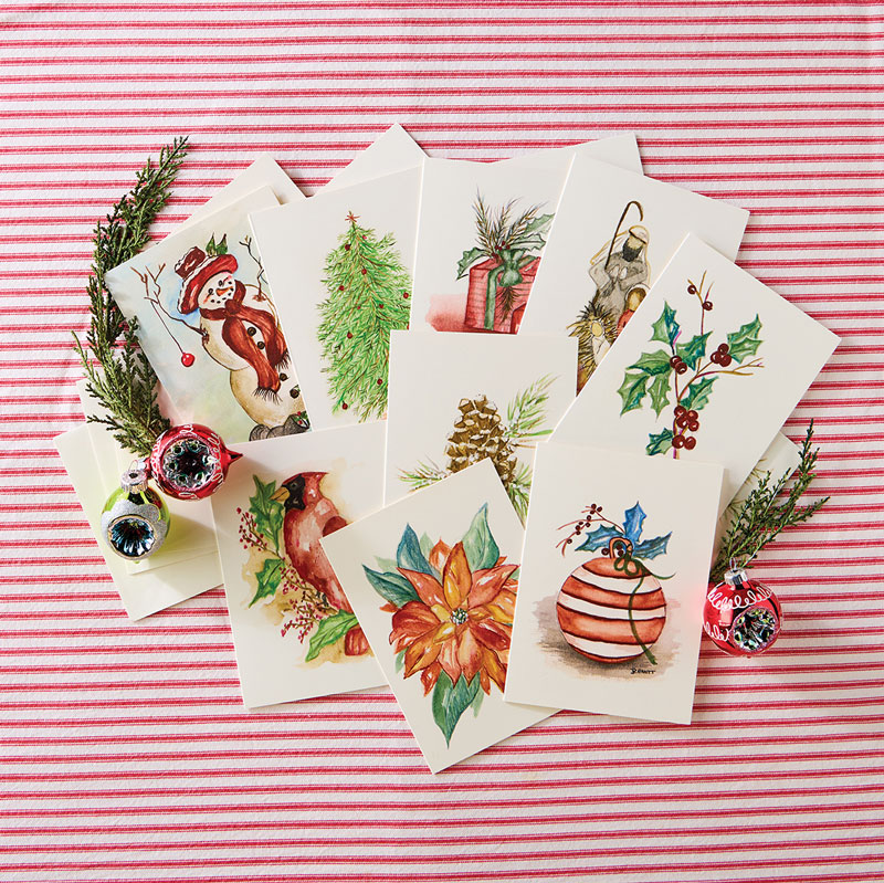 Holiday notecards on red and white stripe fabric with holly and ornament