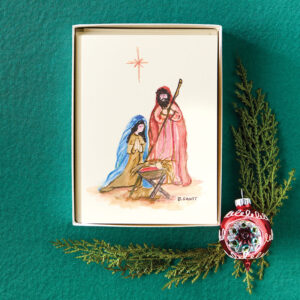 Holiday notecards on green fabric with holly and ornament